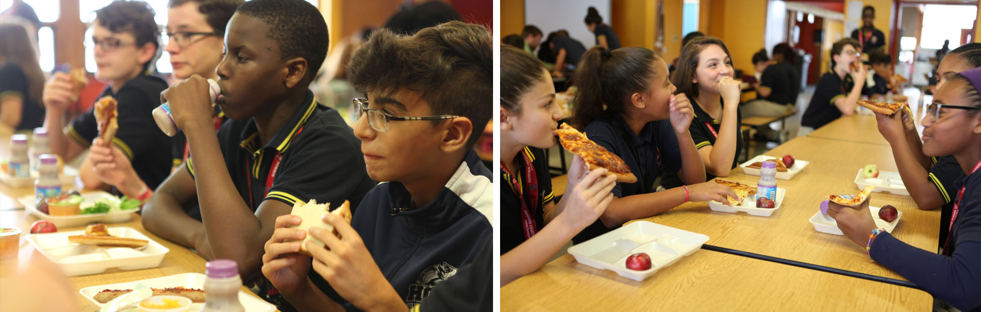 Group of diverse students eating pizza and sandwiches together at long cafeteria tables during lunch.
