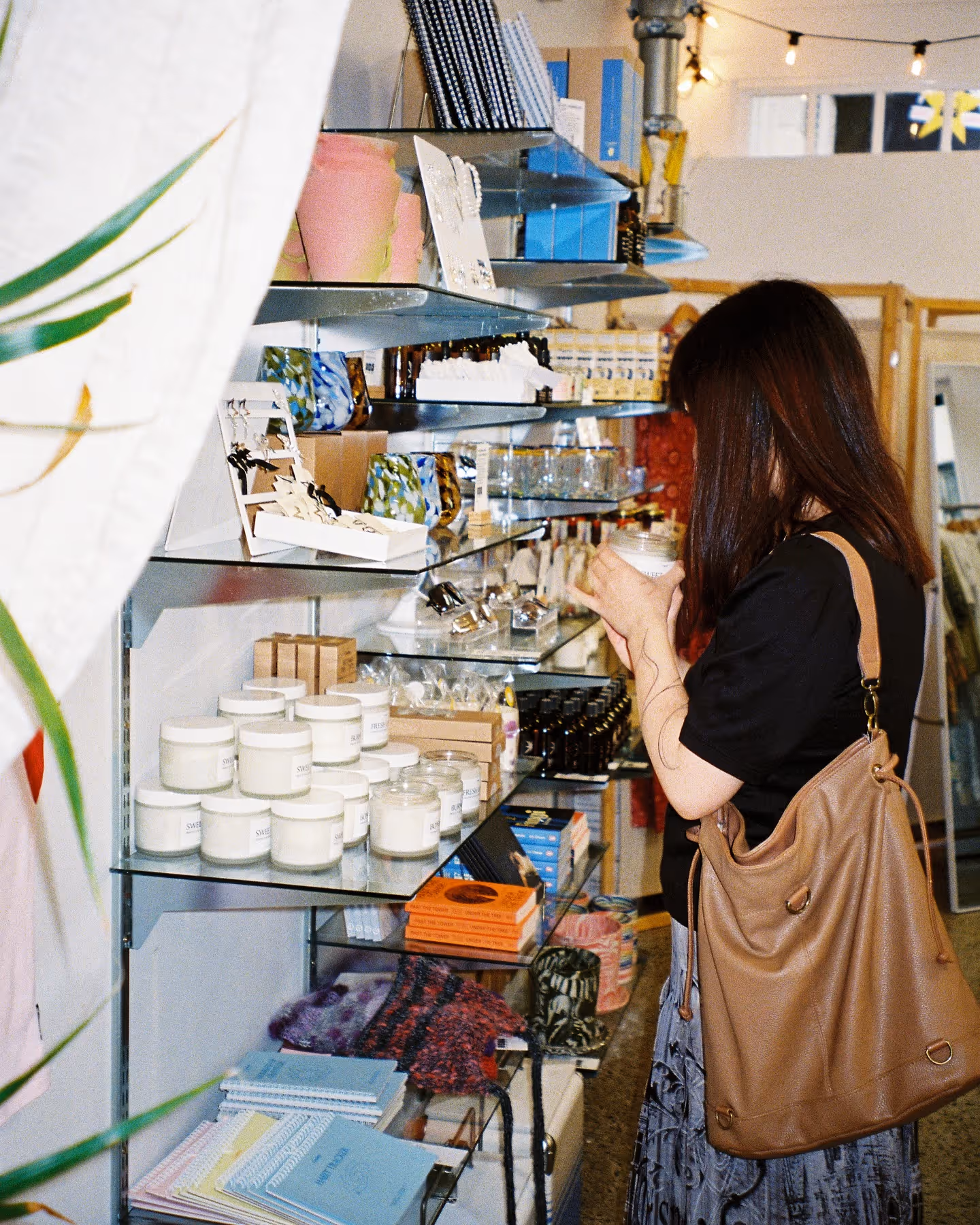 Shopper browsing racks in a vintage clothing store on Karangahape Road, Auckland