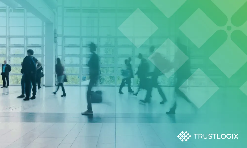 A group of people walking through a lobby.