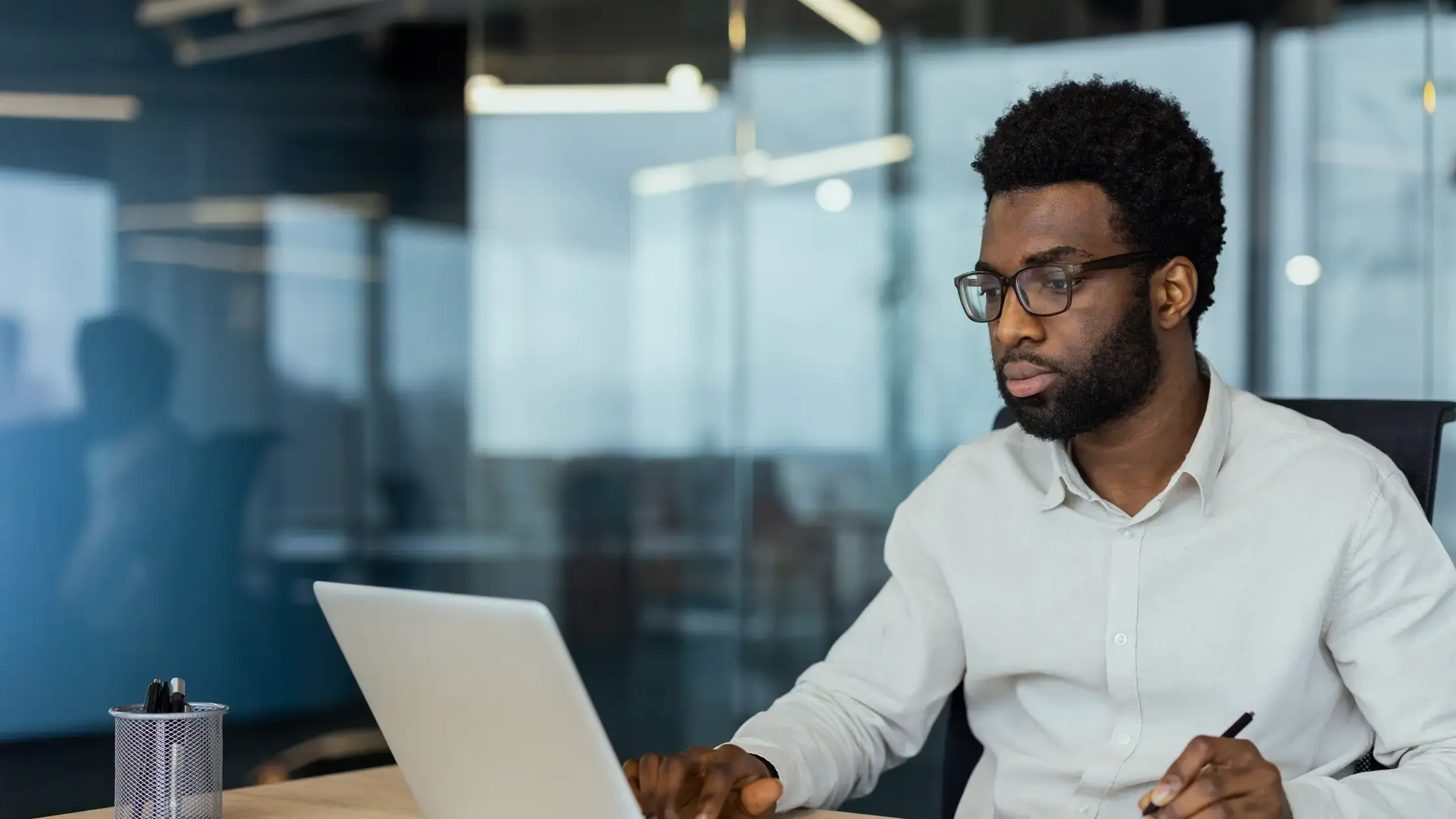 A man sitting in front of a laptop computer.