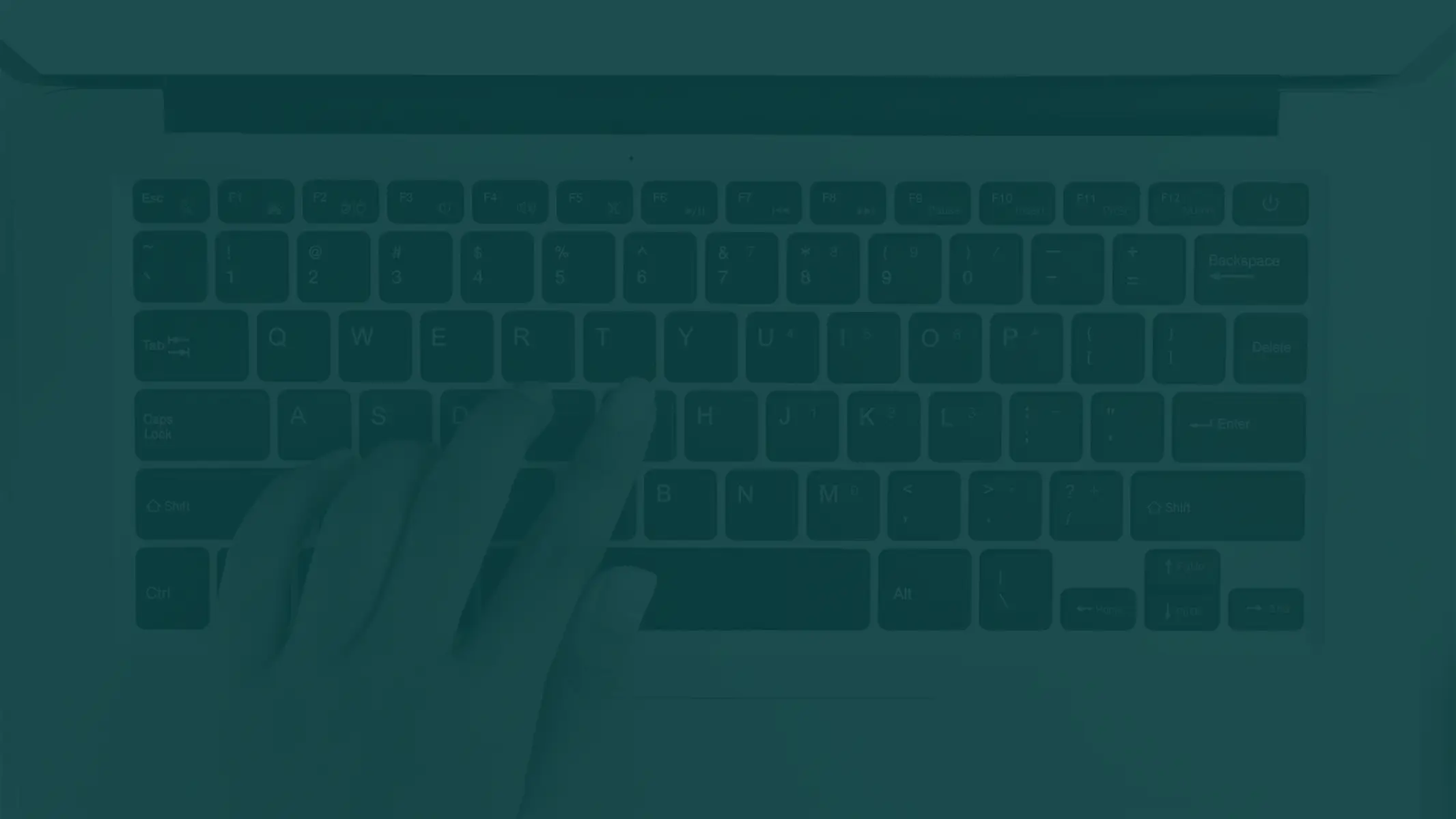 A person typing on a laptop keyboard.