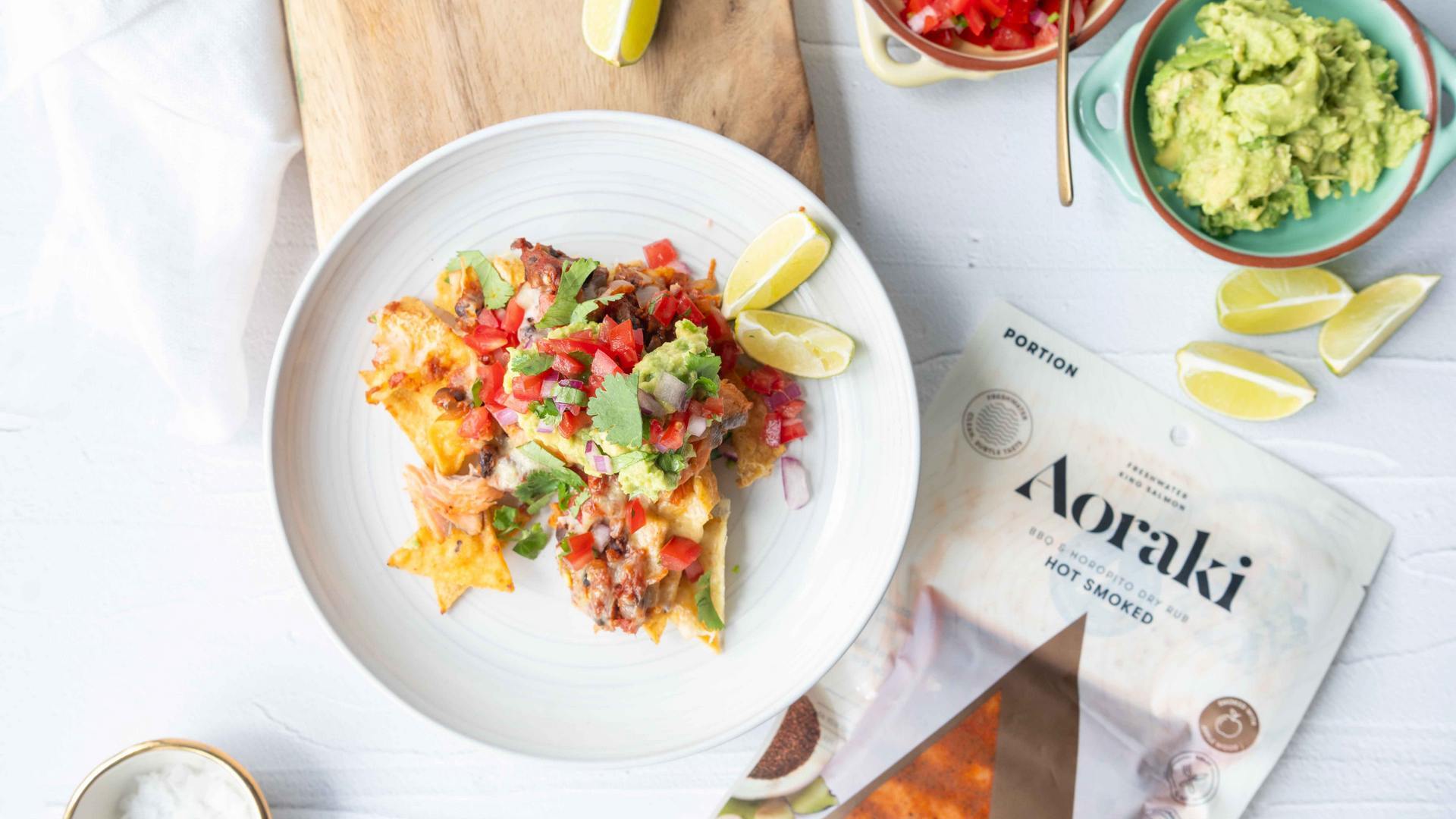 Aoraki smoked salmon nachos topped with avocado, tomato and sour cream