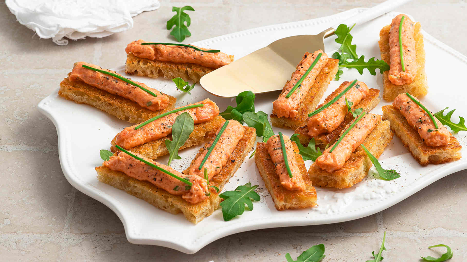 Golden smoked salmon crostini topped with chives