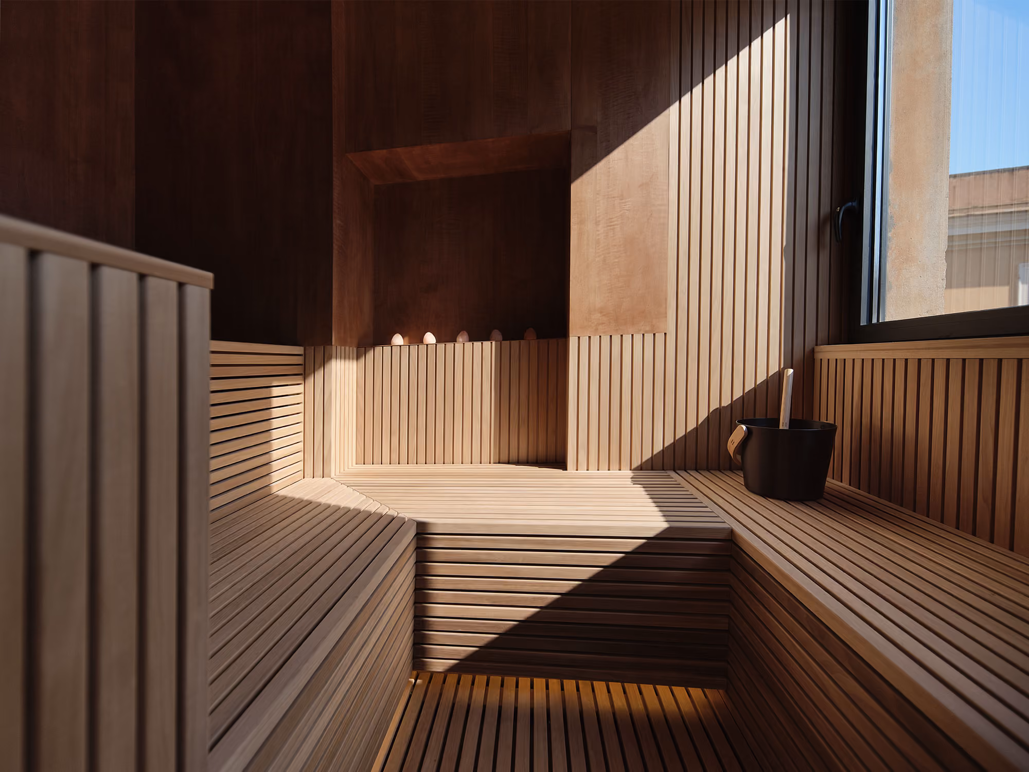 Sauna with wood-slatted benches lit by a strip of warm light