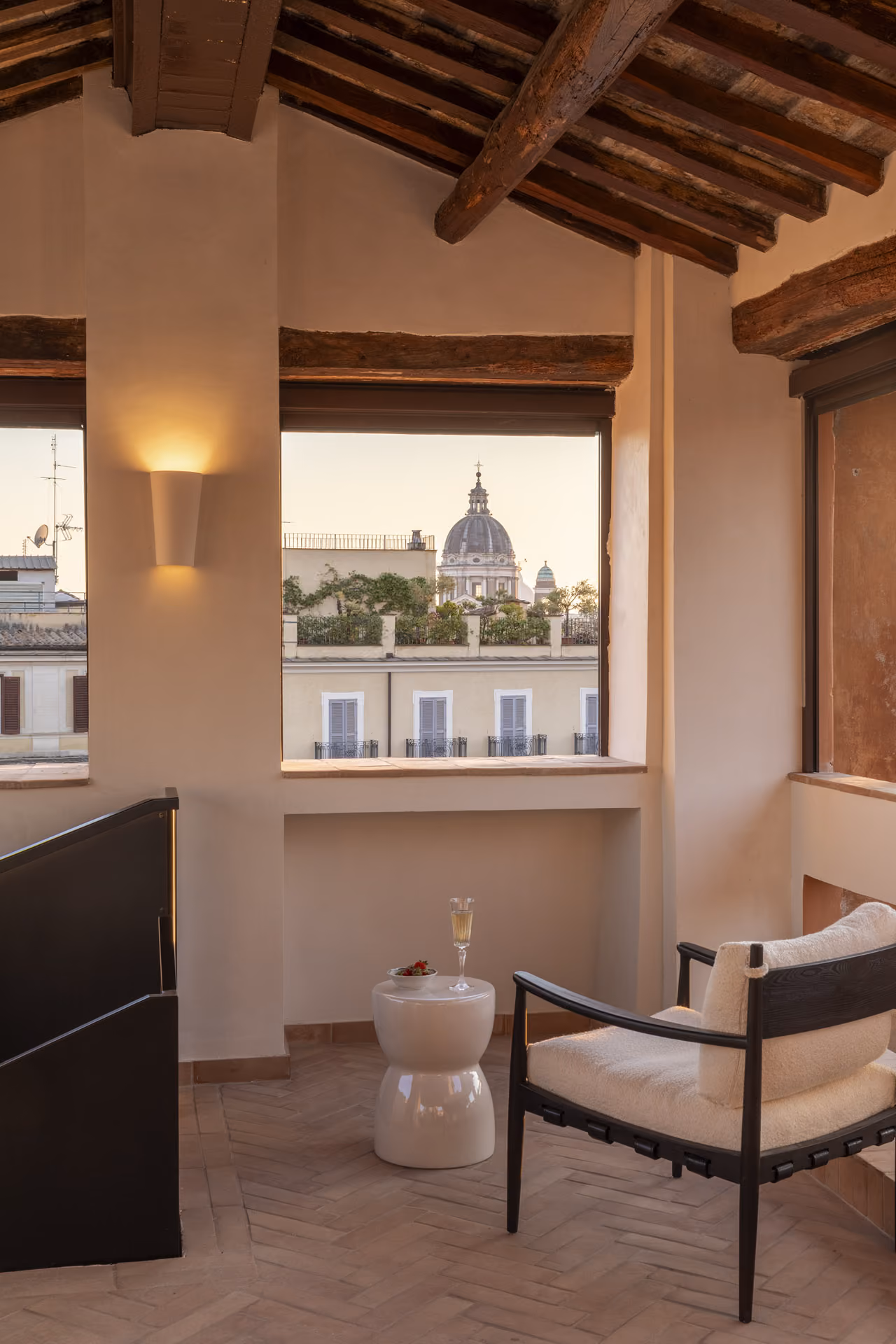 Otium rooftop lounge with an armchair and wooden ceiling beams