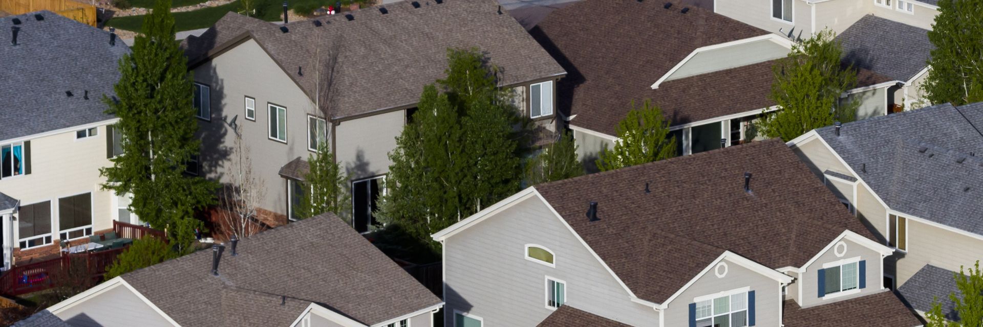 An aerial view of a residential neighborhood with houses and trees