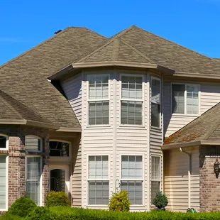 A large house with a lot of windows and a roof