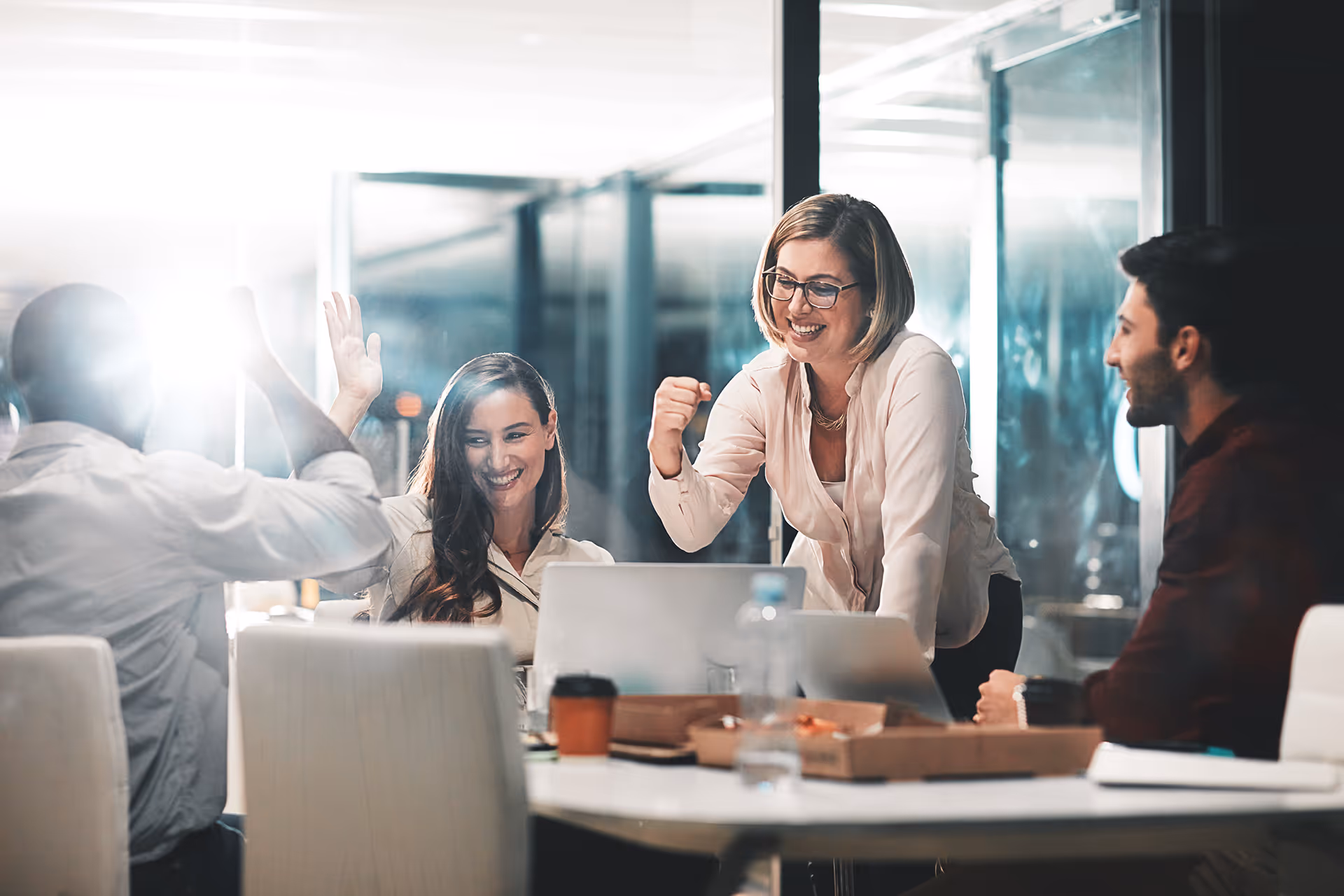 A group of workers celebrating their success together during a meeting