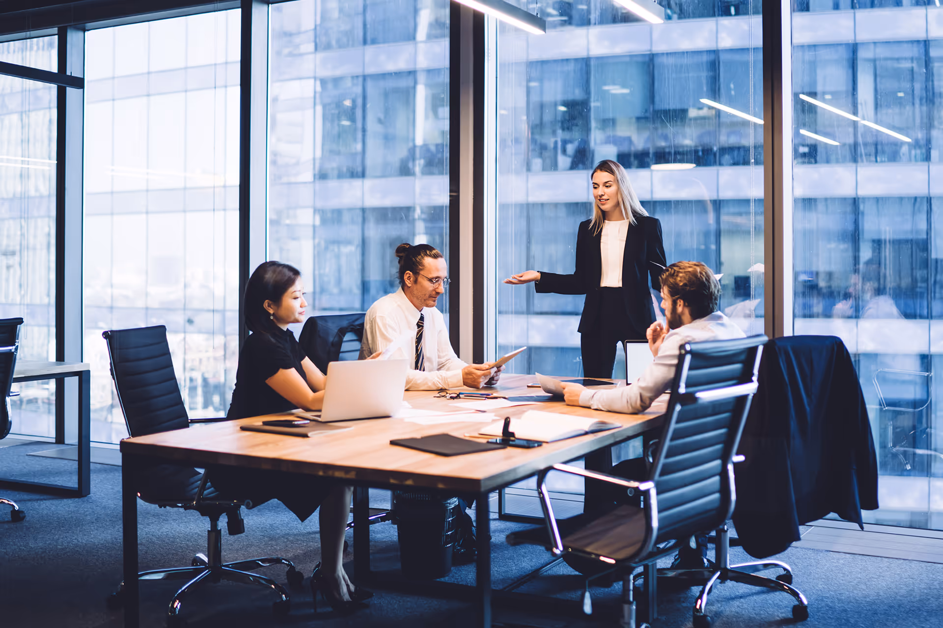 Woman presenting at a business meeting — representing insurance solutions for cruise operators