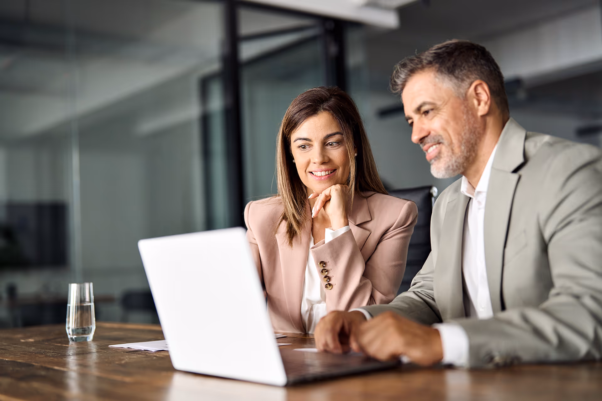 Two people looking at insurance together on a laptop