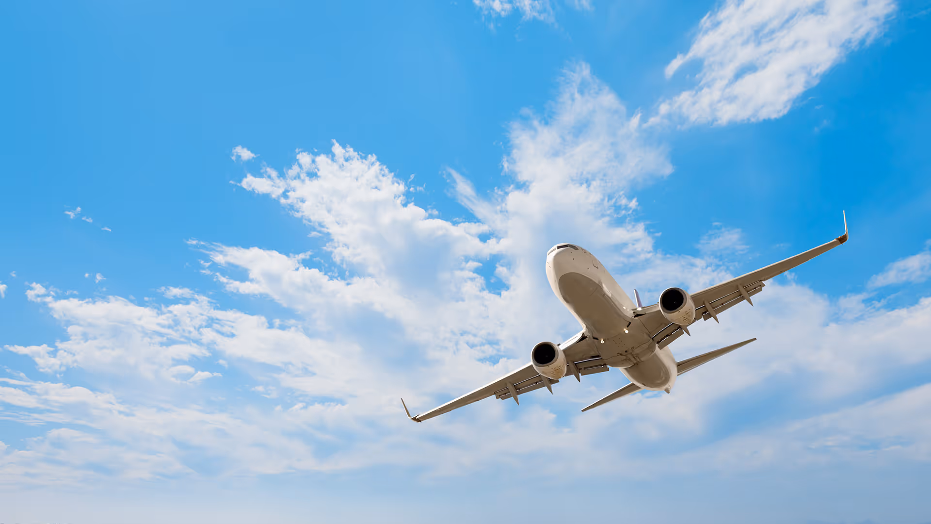 Airplane flying through the sky — representing insurance for the travel sector