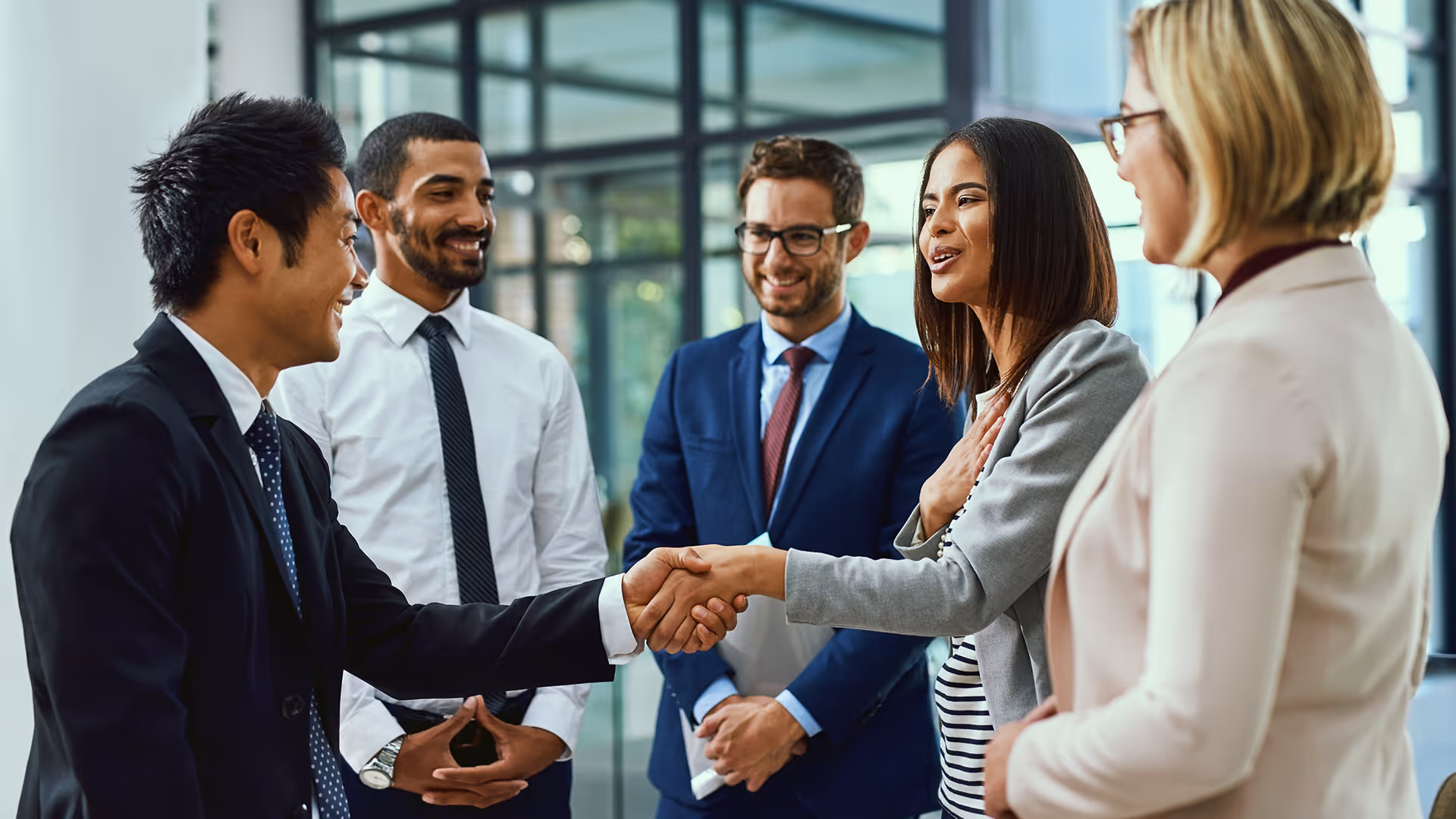A group of people meeting and shaking hands — representing bonding insurance solutions