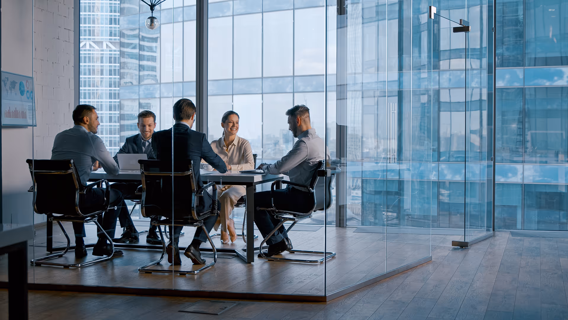 People holding a meeting in a glass meeting room
