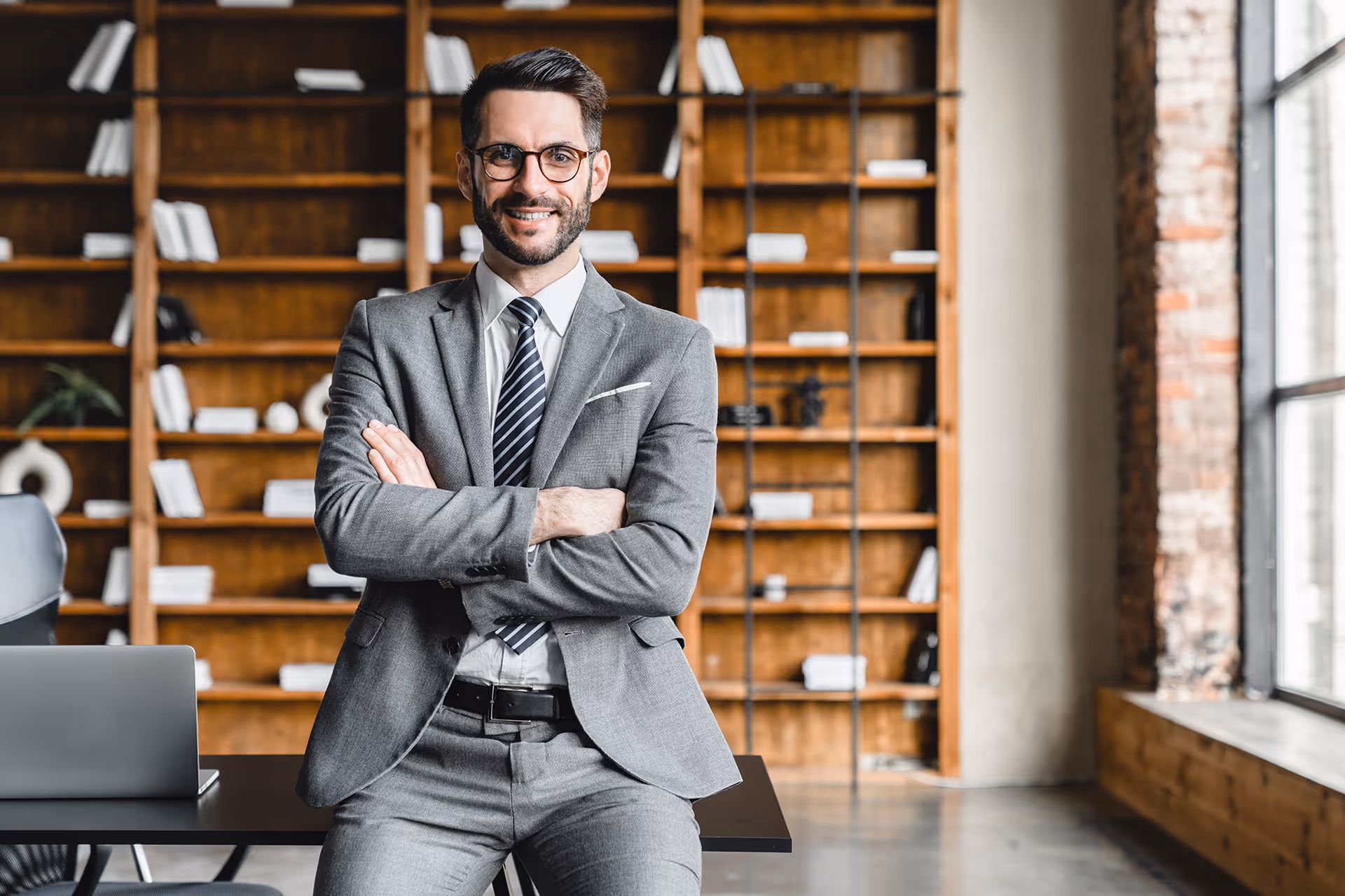 Man sat on desk smiling at camera