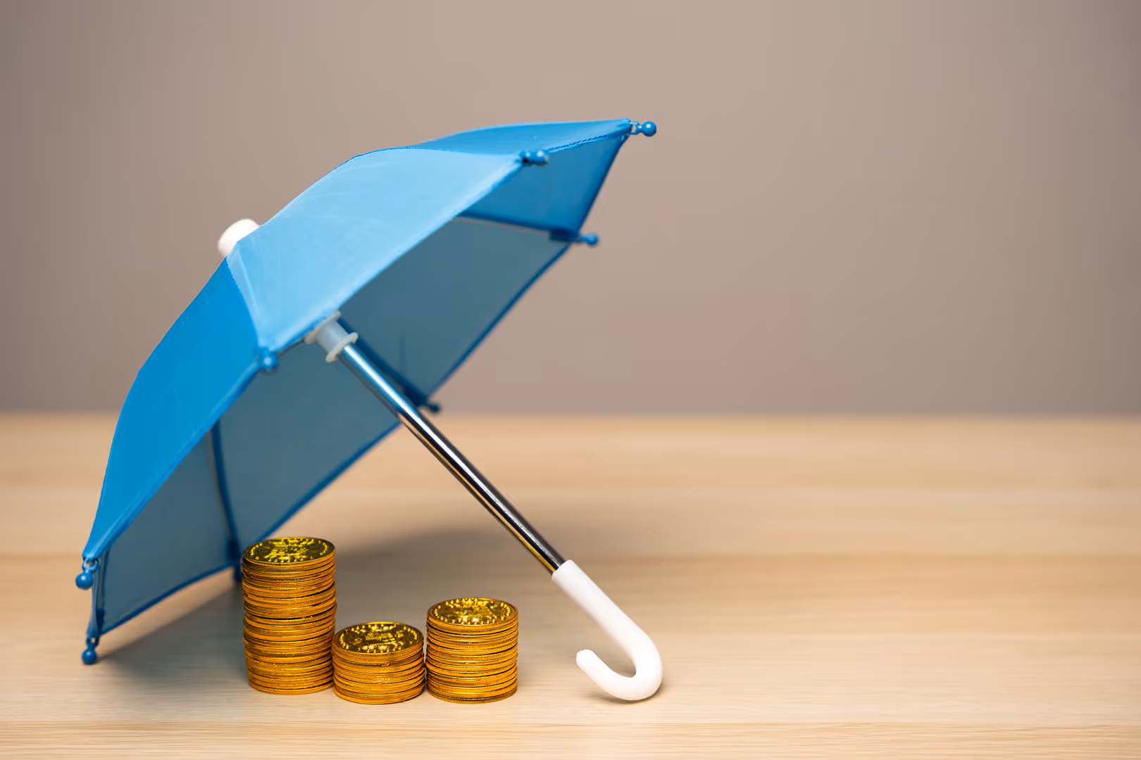 Coins under a blue umbrella