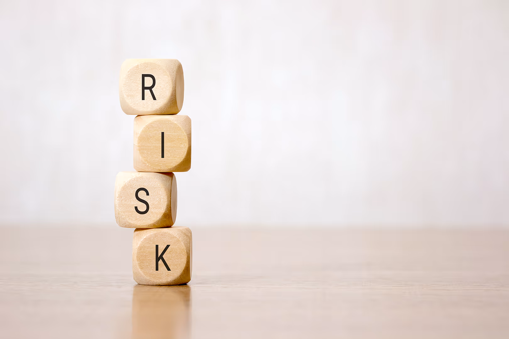 Stacked wooden blocks reading the word risk