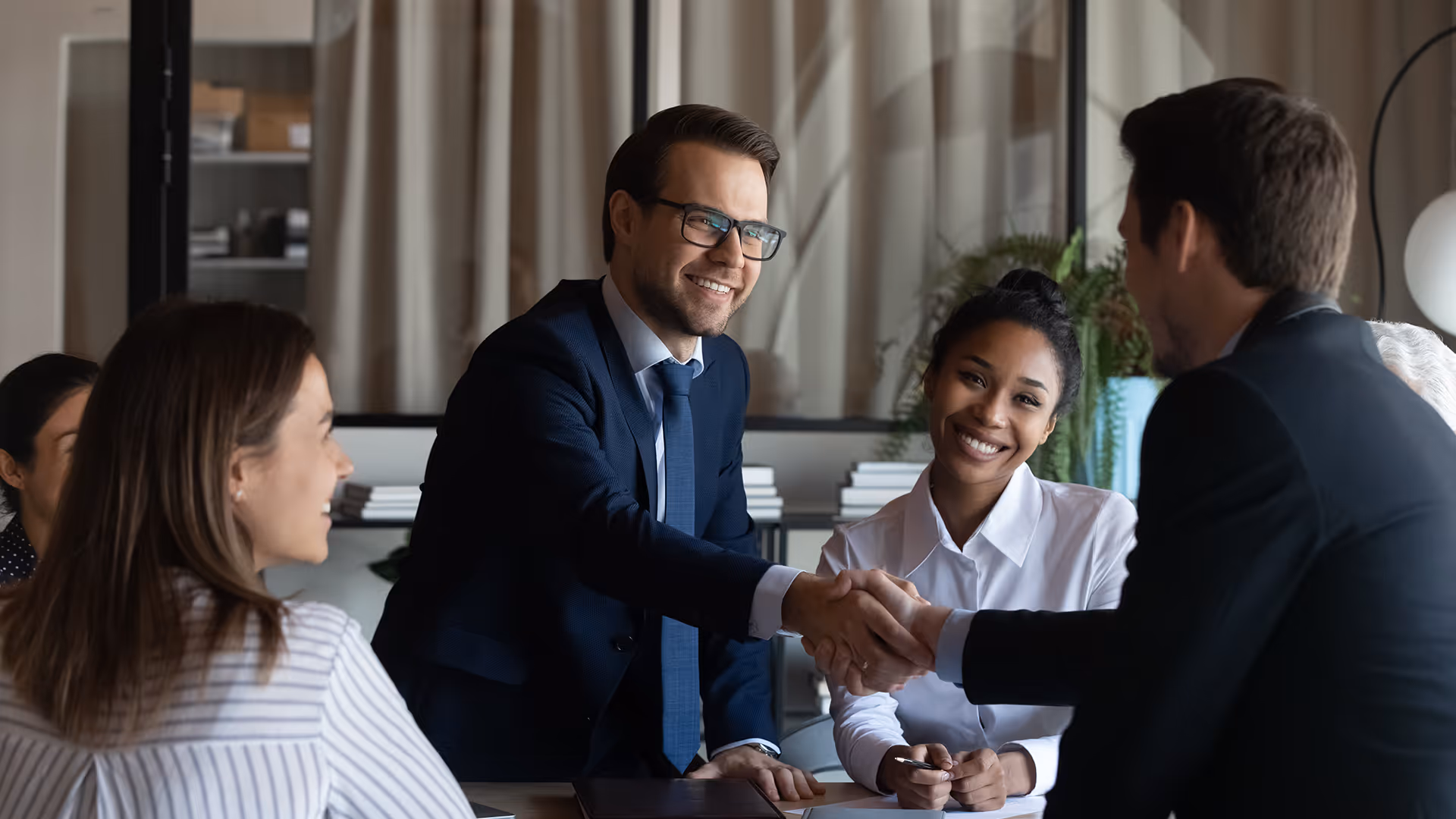 Business leaders shaking hands on a scheduled airline failure insurance policy