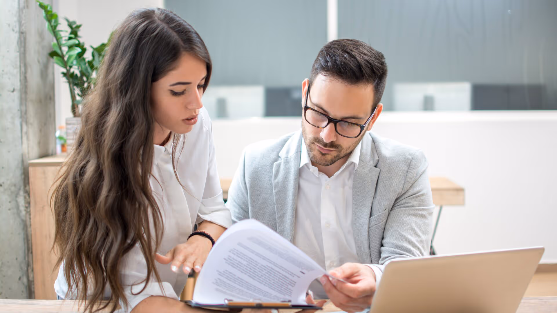 Business people assessing financial document details