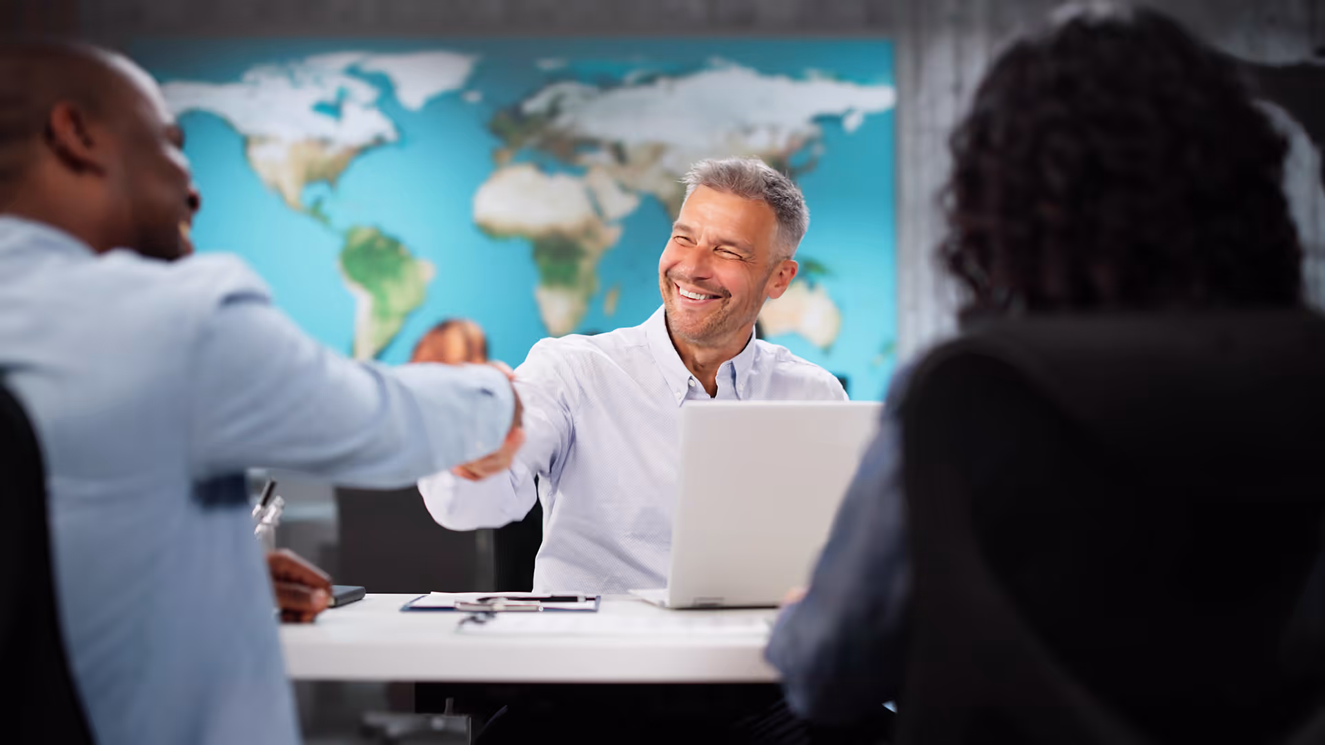 Travel agent shaking hands with a client
