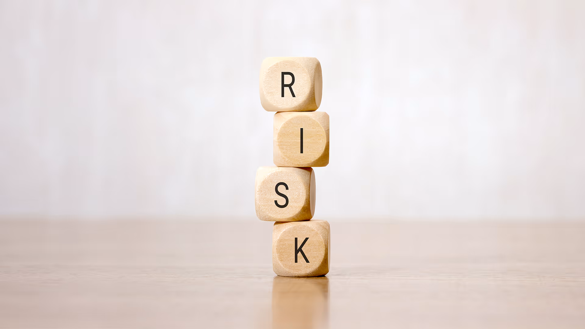 Stacked wooden blocks reading the word risk