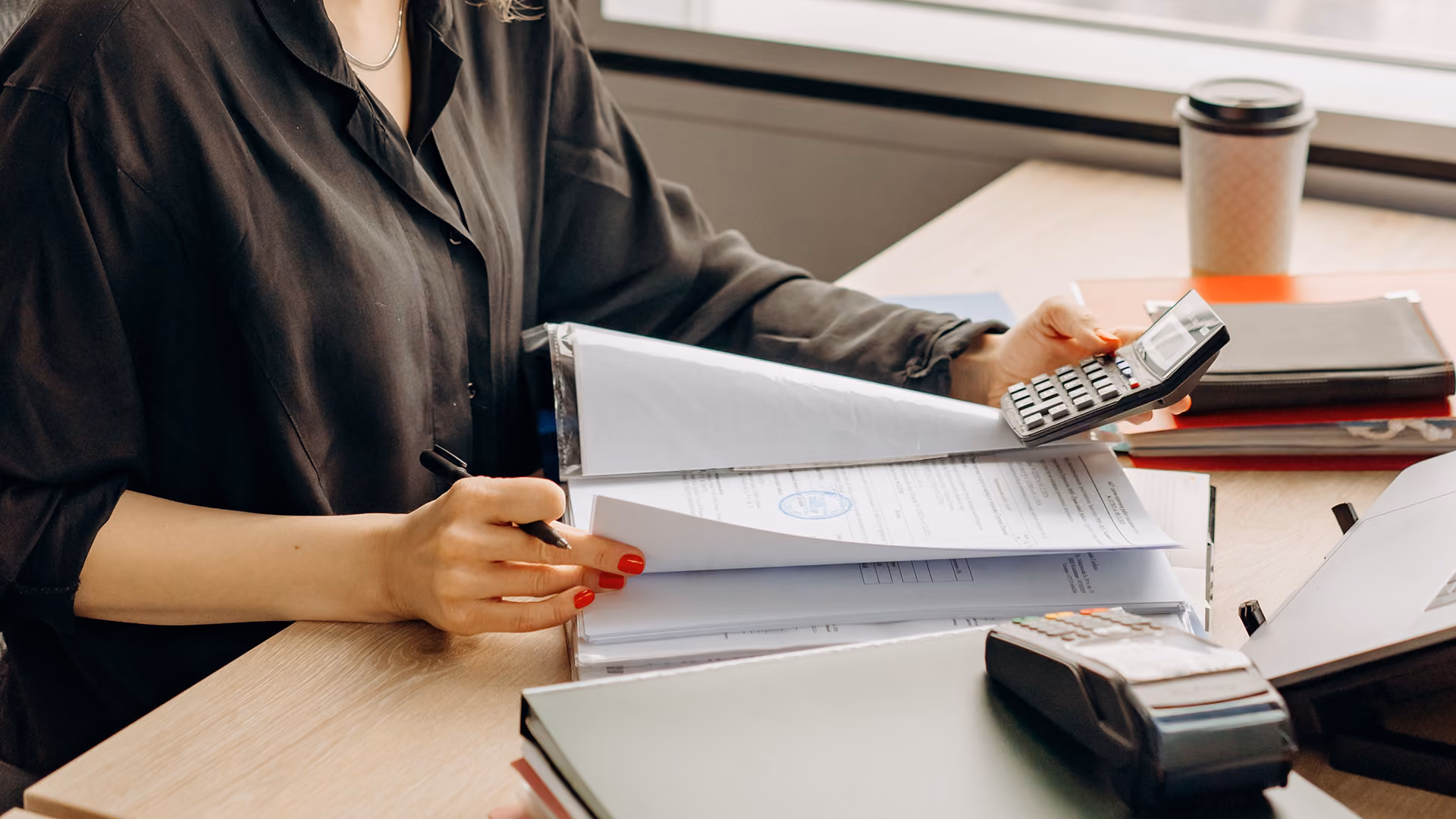 Woman assessing her travel business finances, representing merchant insolvency
