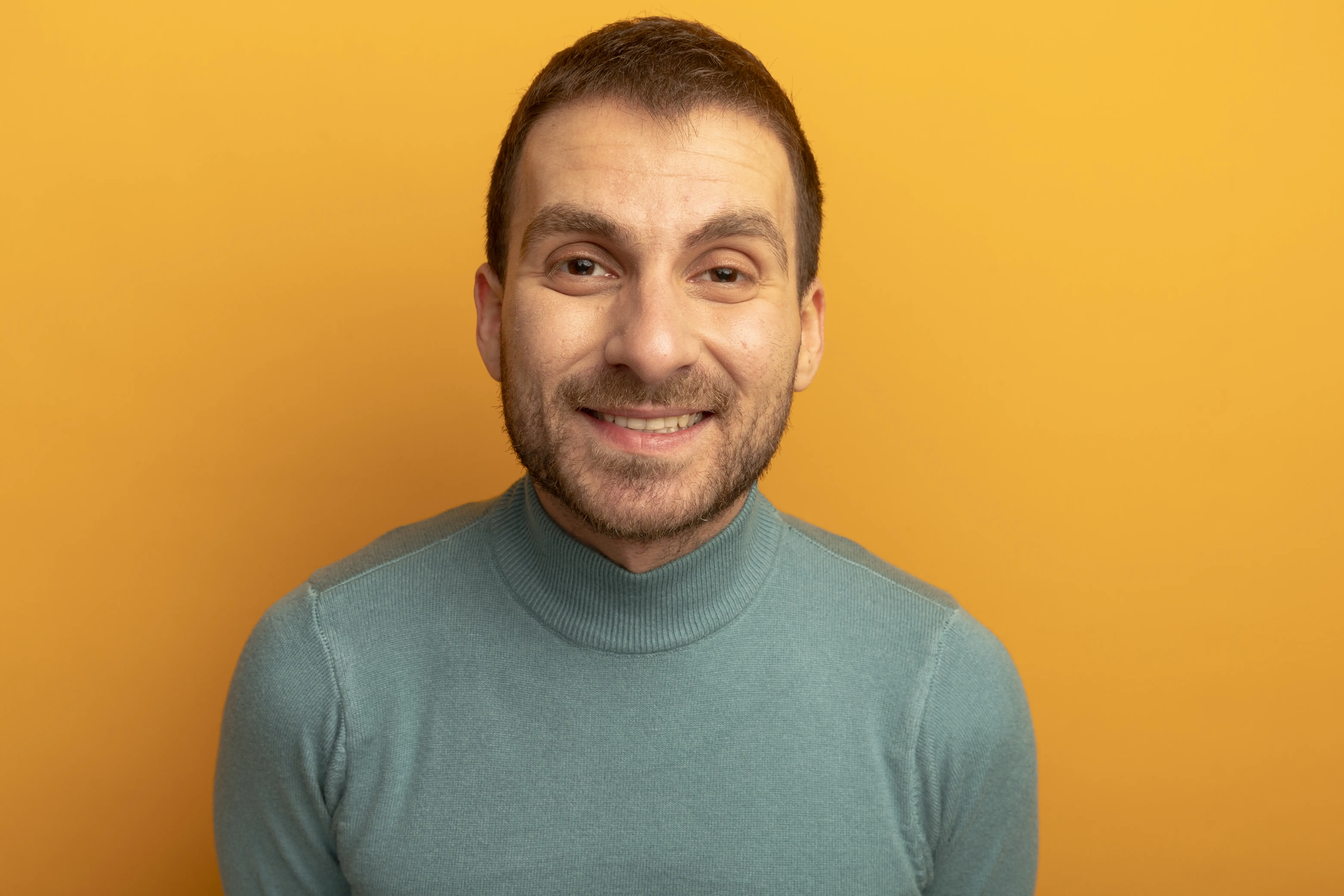 A man wearing a blue shirt and a blue sweater.