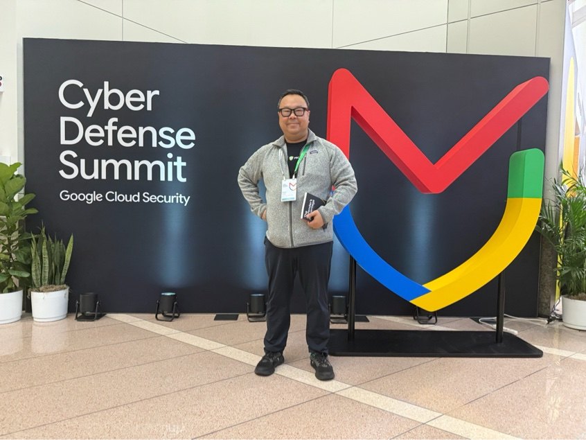 Sam Goh at the Cyber Defense Summit sign, Google Cloud Security