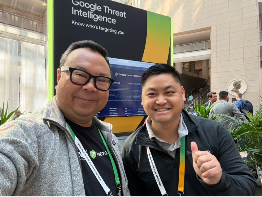 Sam Goh with an attendee at the Google Threat Intelligence stand