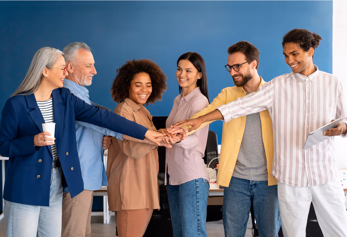A group of people holding hands in a circle.