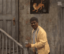SNL GIF of Eddie Murphy going up stairs.