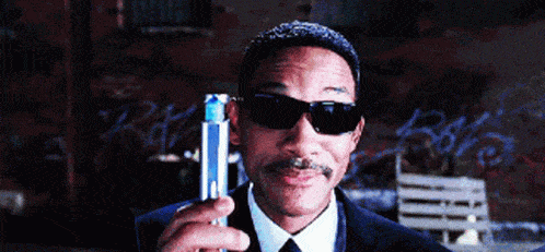 Will Smith from Men in Black holding a device to make you forget manual outreach.