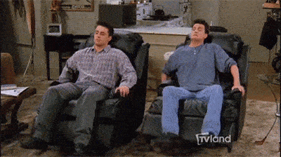 Joey and Chandler relaxing on a chair