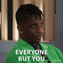 A man in a green suit says "Everyone but you".