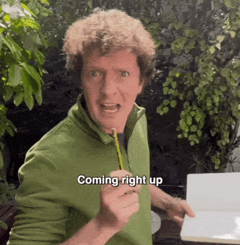 Man holding a notebook and pen saying, 'Coming right up.'