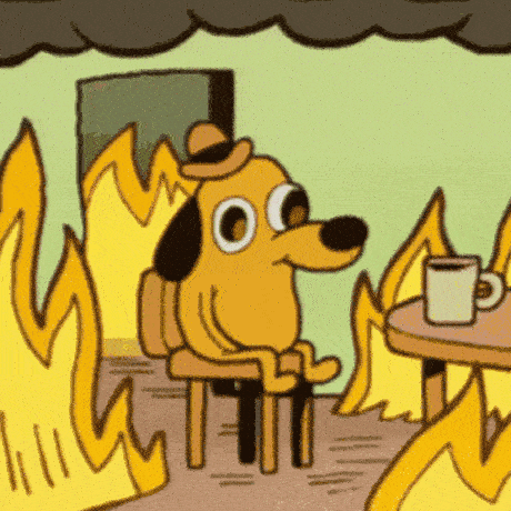 GIF of a dog wearing a bowler hat sitting in a room on fire 