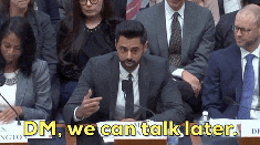 A man in a suit speaks at a podium with the text 'DM, we can talk later.'