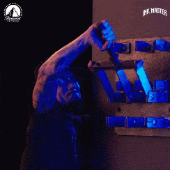 A man pulls a series of blue levers.