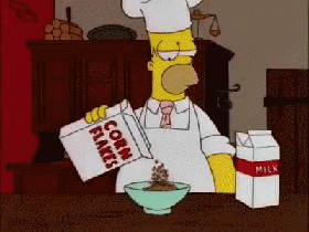 Homer Simpson pouring cornflakes into a bowl.