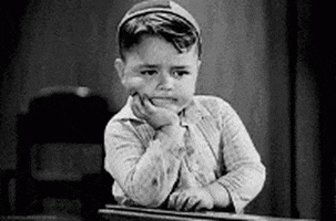 gif of a young boy waiting with his hand on his chin.