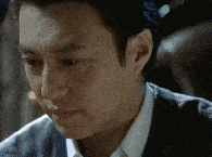 A man looking down with a sad expression.