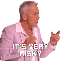 A man in a pink jacket and white shirt gestures with his hands, with white text overlayed that reads 'IT'S VERY RISKY'.