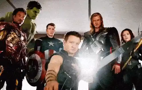 Hawkeye aiming an arrow with other Avengers.