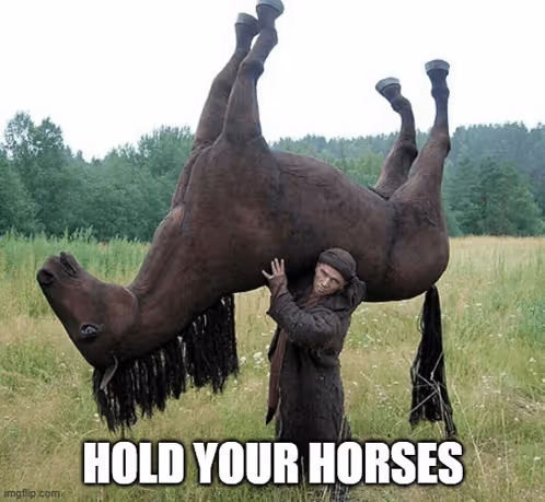 A man in a field struggles to lift a horse above his head, with the text