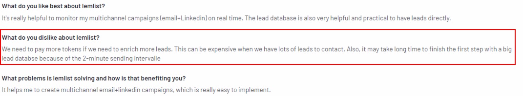 A highlighted section of a review for lemlist, stating a dislike about paying more tokens for lead enrichment and slow processing.