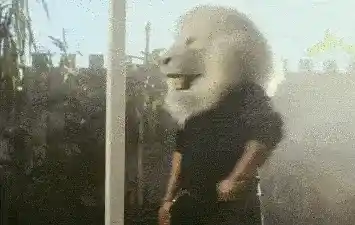 Man wearing lion mask giving a thumbs up