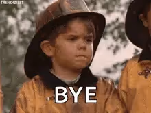 A young boy in a firefighter costume with a pouty expression and the word "BYE" superimposed on the image