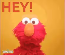 Elmo puppet with wide eyes saying