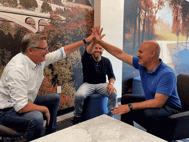 Three men doing high five