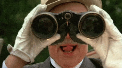 Man with binoculars looking excited