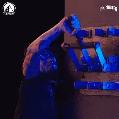 A man pulls a series of blue levers.